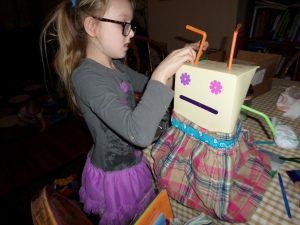 Caollin making her little robot person. She inspired the other kids to make them, as well.